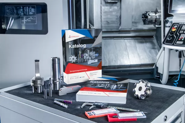 The picture shows the Ceratizit Group's product catalog in bound form, presented with some of the company's tool parts on a workstation. 
