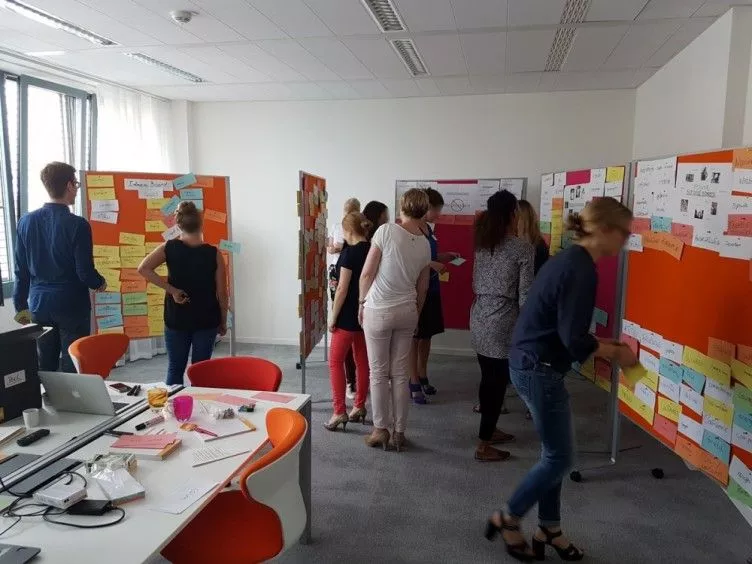 A naming workshop in which many name ideas are collected and posted on pin boards.