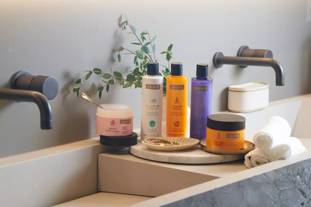 Wellness with ORINIQ Products from ORINIQ stylishly draped in a bathroom.